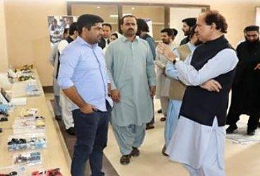 Visitors at an SIA exhibition of participants’ work
